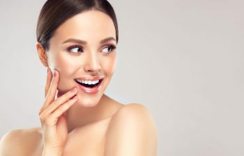 Youthful face of a beautiful happy woman.