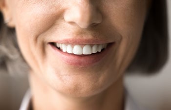 Close up of beautiful older woman smile after whitening procedure