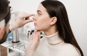 Consultation with ENT before rhinoplasty plastic surgery to change nose shape and improve breathing