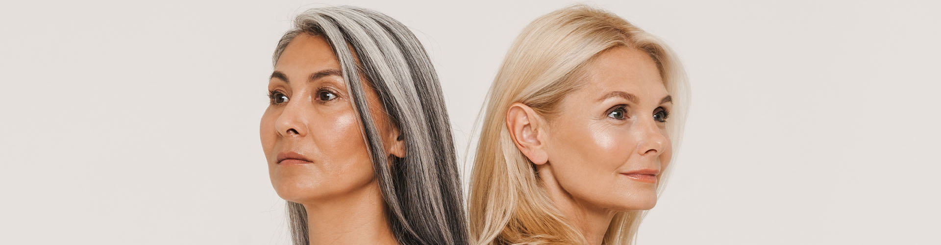 Mature multiracial women with gray hair wearing t-shirts posing at camera isolated over white background