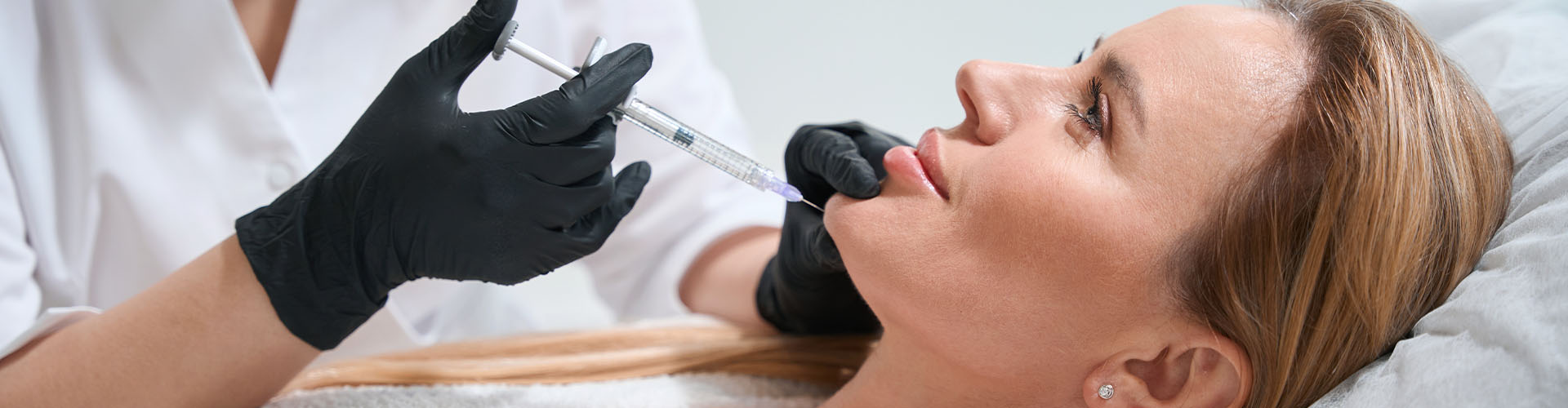 Blonde client receives a rejuvenating chin injection