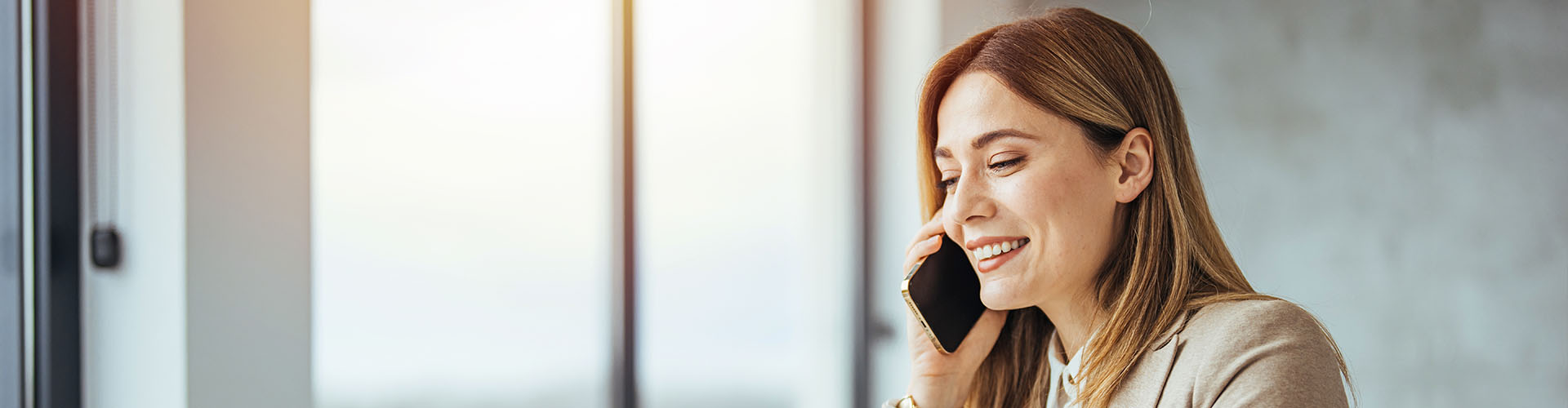 businesswoman using a computer and talking on the phone