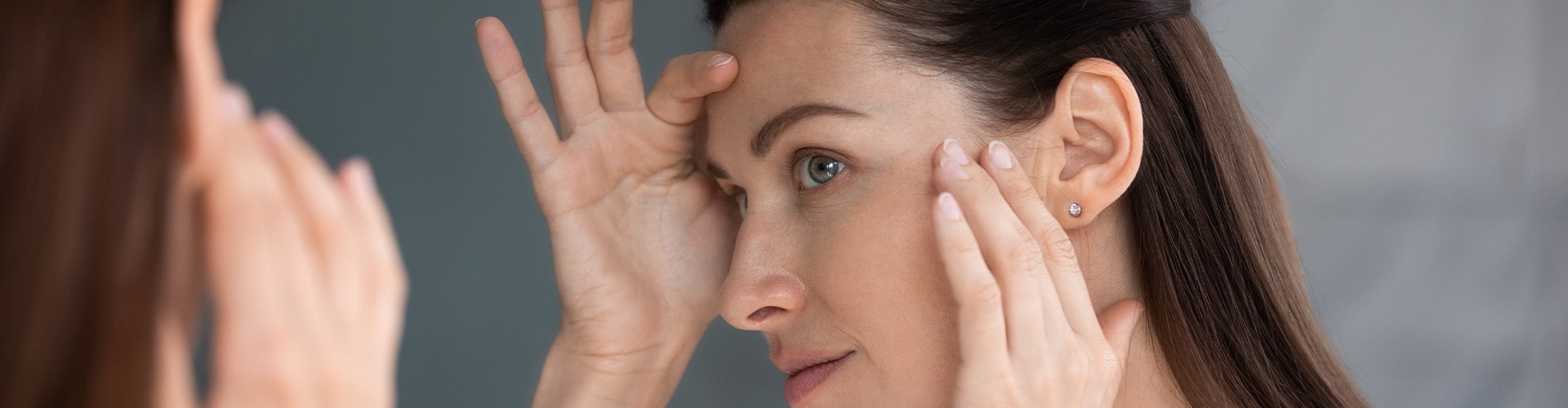 Close up of woman looking in mirror check face